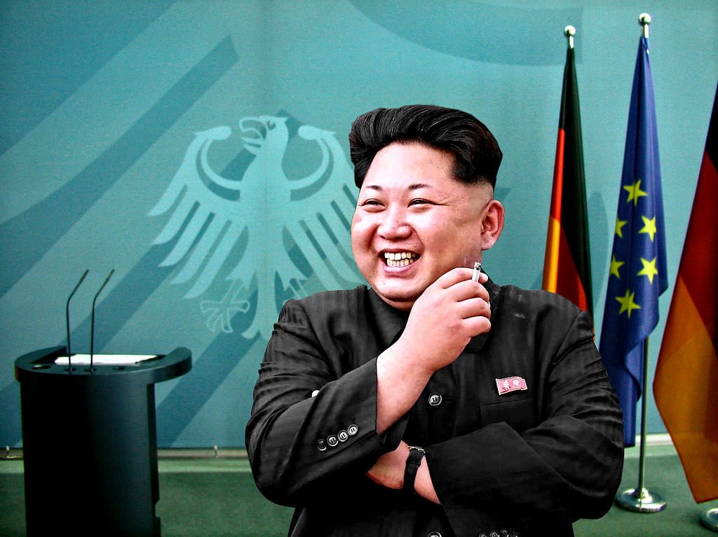 Kim Jong-un smiling, holding a cigarette