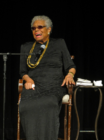 Dr. Maya Angelou sitting on a stage speaking
