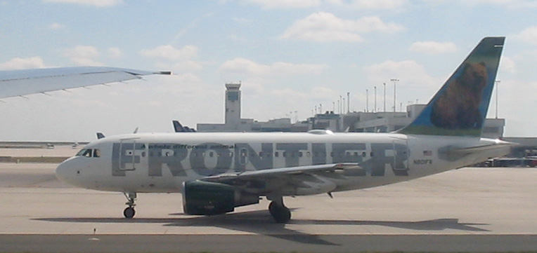 Frontier Airlines plane parked at airport